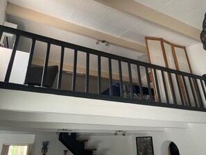 A multi-level interior with a staircase, a balcony, and a door with a letter 'b' marking. - Luxurious villa with a pool, close to the beaches and the harbor. (Saint-Cyprien)