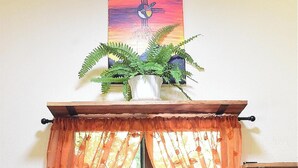 A kitchen with a window, a sink, and a potted plant on the windowsill. - Home in tranquility and peace of the jungle situated in a beautiful garden. (Cozumel)