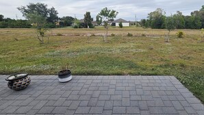 A paved patio area with a potted plant and a decorative item. - 3-bedroom house in peaceful Fort Myers near Lehigh Acres with AC comfort (Fort Myers)