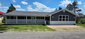 A two-story building with a covered porch and a garage. - Luxury Lakeview Home with Panoramic Views. Sleeps 10 (Golden)