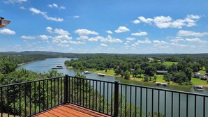 A balcony with a view of a river, boats, and surrounding greenery. - Luxury Lakeview Home with Panoramic Views. Sleeps 10 (Golden)