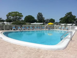 A rectangular swimming pool with a white edge, surrounded by a brick deck. - Snowbird Retreat in Beautiful Bradenton Florida! (Bradenton)