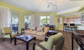 A hotel room with a sofa, chairs, a coffee table, a dining area, and a kitchen. - Family Adventure Getaway on the Big Island!
Perfectly located!!! (Cedar Hills)
