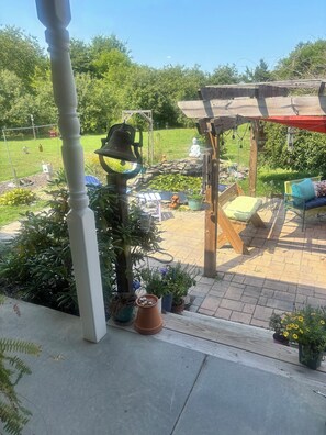 A garden patio with a pergola, seating, and potted plants. - Tranquil country retreat: Relax, Unwind & Recharge” (Delmar)
