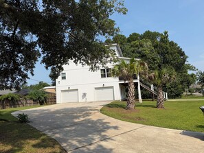 A two-story house with a garage, a covered porch, and a well-maintained lawn. - Paradise Beach on Perdido Bay• Dog Friendly (Pensacola)