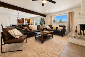 A modern living room with a sectional sofa, a coffee table, and a fireplace. - Aloha Scottsdale, Poolside Old Town Retreat (Scottsdale)