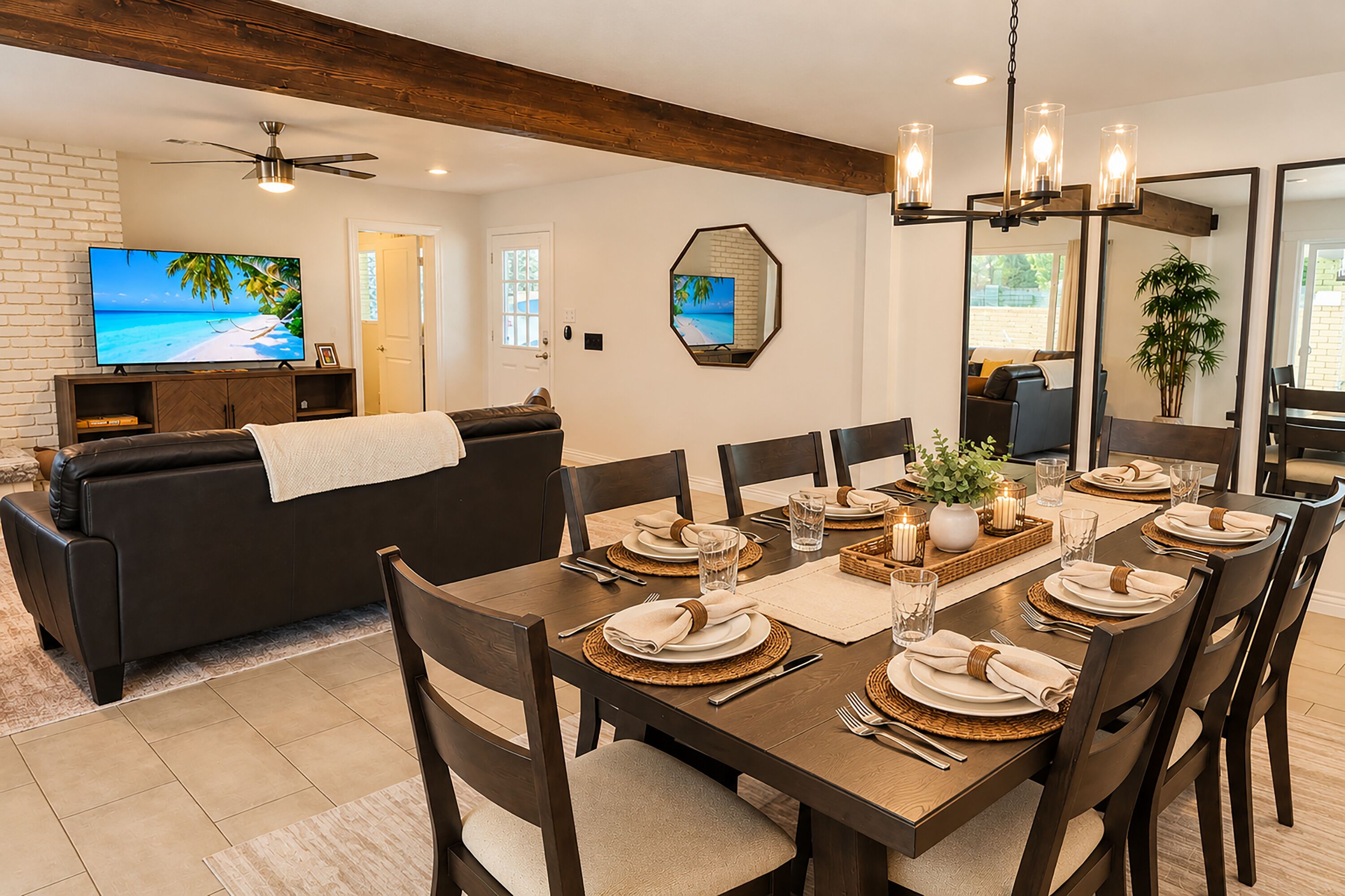 A dining area with a wooden table set for four, surrounded by dark wooden chairs.