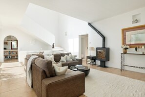 A modern living room with a sofa, coffee table, and a fireplace.