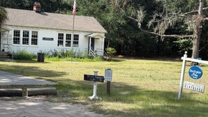 A building with a sign indicating school grounds and a coffee shop. - Nonna's Cottage,Spacious 3-bedroom Stand alone house,cart and landtrans included (Daufuskie Island)