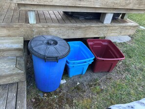 A wooden structure with a trash bin and two plastic containers. - Great family retreat for all ages! Relax, recharge and reset. (Whangarei)