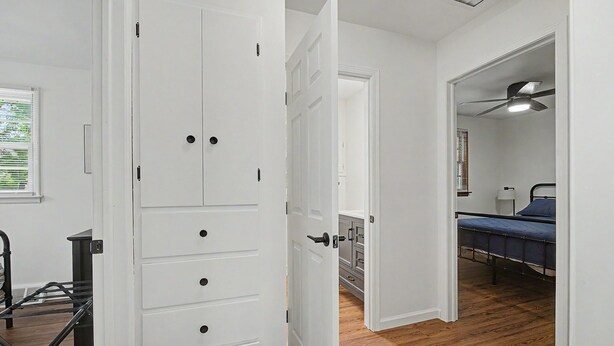 A room with a bed, a desk, and a wardrobe.