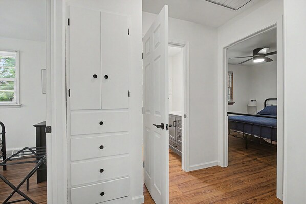 A room with a bed, a desk, and a wardrobe.