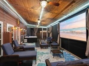 A sunlit room with a large window overlooking the sea, furnished with lounge chairs and a hot tub. - Lake Guntersville / Adults-Only Retreat + Luxury Playroom (Langston)