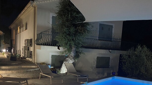 A swimming pool with a blue hue, surrounded by lounge chairs and a building with a balcony. - Luxury 8-person villa on the Côte d'Azur with a pool and ocean views from every room (Fréjus)