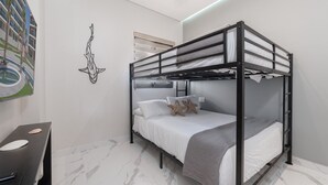 A bunk bed with a headboard, white bedding, and starfish pillows. - 3-bedroom luxury beachfront condo - Encantame Soleil with lazy river, waterslide (Puerto Penasco, Son)