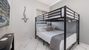 A bunk bed with a headboard, white bedding, and starfish pillows. - 3-bedroom luxury beachfront condo - Encantame Soleil with lazy river, waterslide (Puerto Penasco, Son)