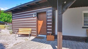 A wooden building with a door marked '97' and a bench outside. - Černý Důl by Interhome (Cerny Dul)