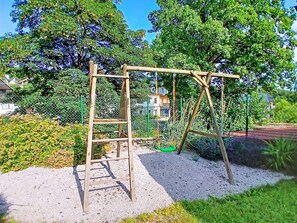 A playground with a wooden swing set and a ladder. - Černý Důl by Interhome (Cerny Dul)