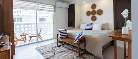 A modern bedroom with a bed, bedside table, and a view of the outside.