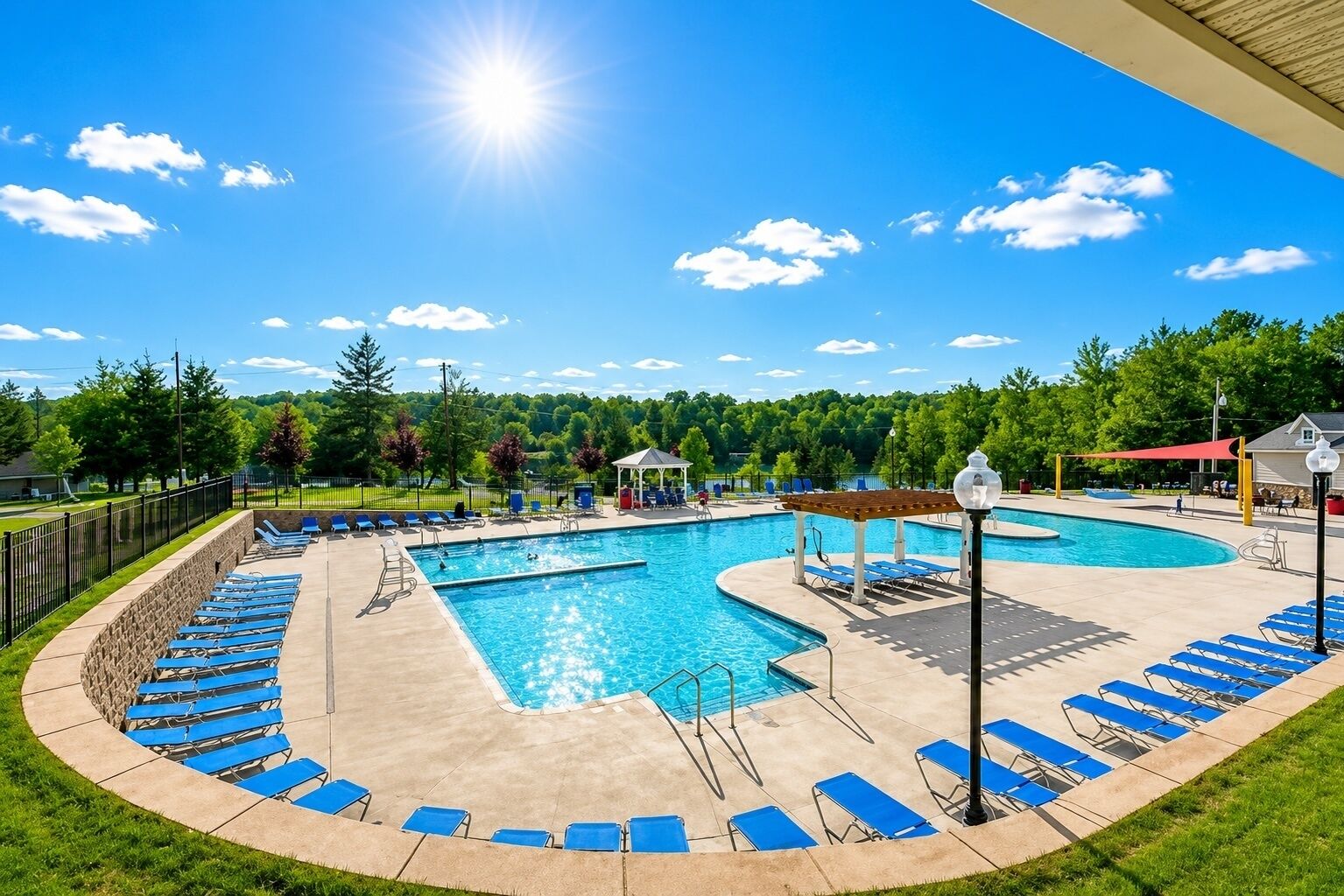 A swimming pool with multiple lanes, sun loungers, and a gazebo.