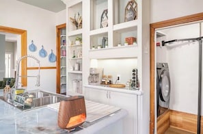 A modern kitchen with a built-in dishwasher, a coffee maker, and a microwave. - Spacious Historical Oasis (Allentown)