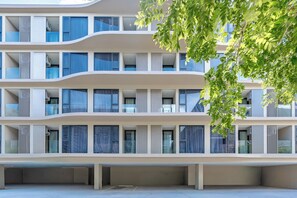 A multi-story building with balconies, large windows, and a flat facade. - Bellevue Beachfront Apartments (Choeng Thale)