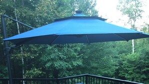 An outdoor deck with wicker furniture, a blue umbrella, and a fire feature. - Mont-Tremblant Escape:Cozy Fireplace & Hot Tub
Entire Home
Sleeps 6
Pet Friendly (Mont-Tremblant)