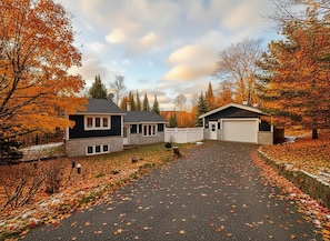 A two-story house with a driveway and a garage. - Mont-Tremblant Escape:Cozy Fireplace & Hot Tub
Entire Home
Sleeps 6
Pet Friendly (Mont-Tremblant)