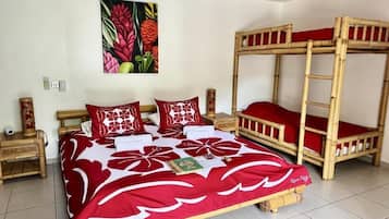 A room with a bed, a bunk bed, and a wall-mounted painting.
