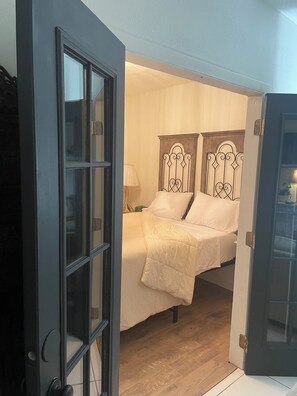 A room with a bed, a door, and a lamp. - Lovely “Dreamy Nook at Cocoa Village” (Cocoa)