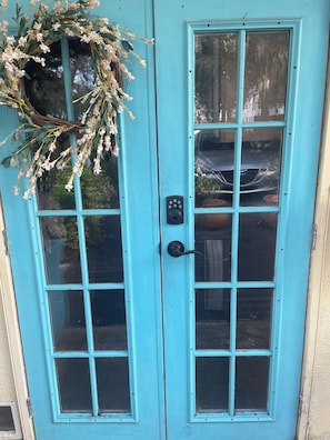 A turquoise double door with a keyhole and a lock.