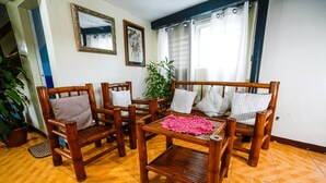 A living room with wooden furniture, a coffee table, and a potted plant. - Watson Residence w/Private pool, Billiards, and Tennis Court (Central Visayas)