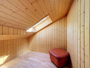 A room with wooden walls and a sloped ceiling with skylight. - Haus Wasserfall by Interhome (Saas-Almagell)