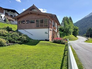 A two-story chalet with a sloped roof, wooden exterior, and a small balcony. - Resimini by Interhome (Pettneu am Arlberg)