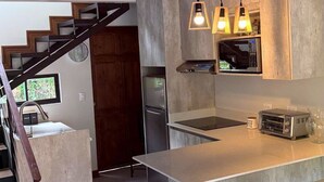 A modern kitchen with a central island, stainless steel appliances, and pendant lighting. - Alto Bosque. Mountain chalet with a private hot tub ⛰️🌿 (Berlín)