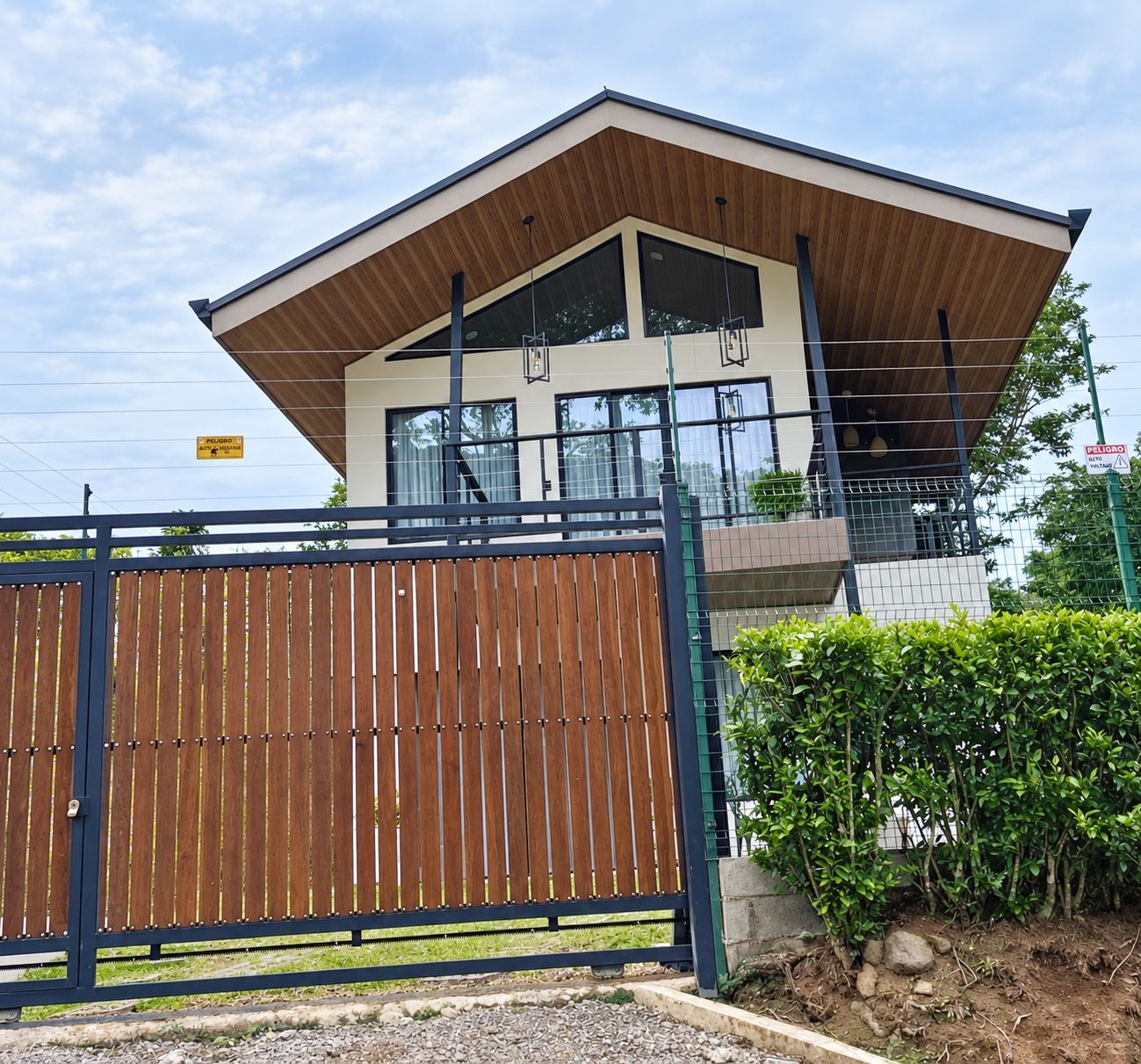 A modern two-story building with a flat roof and large windows.