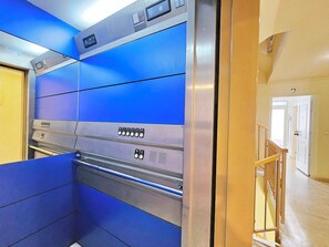A modern elevator with blue panels and a control panel with buttons. - Apartamento Alba 6 by Interhome (Cartagena)