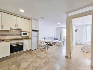 A modern kitchen with white cabinets, a microwave, and a built-in oven. - Apartamento Alba 8 by Interhome (Cartagena)