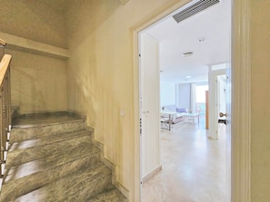 A staircase leading to a room with a bed, a table, and a chair. - Apartamento Alba 8 by Interhome (Cartagena)