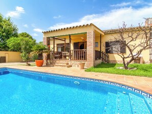 A house with a swimming pool, a patio with outdoor furniture, and a garden with trees. - Sunrise by Interhome (Vilajuiga)