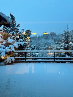A snowy landscape with a wooden railing and snow-covered trees. - Place of worship   (San Carlos de Bariloche)