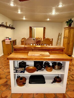 A kitchen with a wooden countertop, a sink, and various pots and pans. - Charming Southwest Hacienda 4Br/4.5Ba (Anthony)