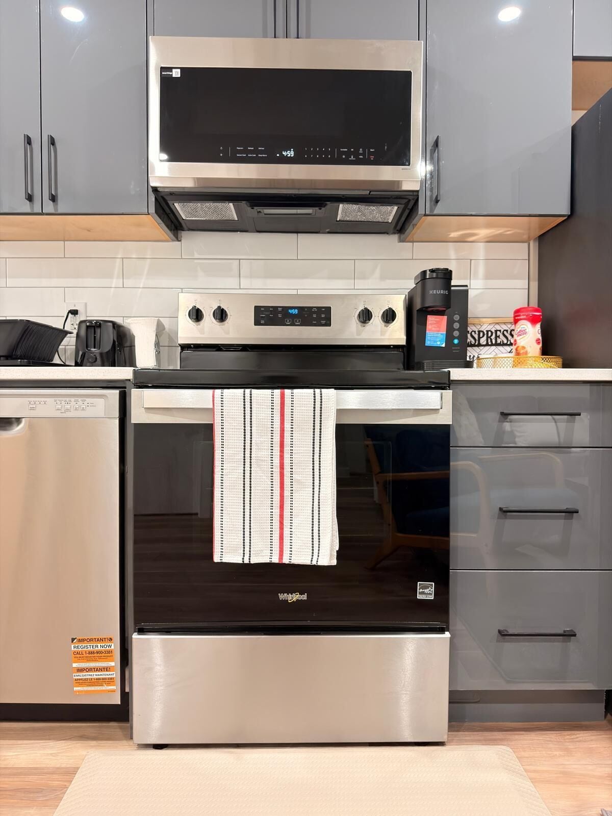 A kitchen with stainless steel appliances, including a microwave, oven, and coffee maker.