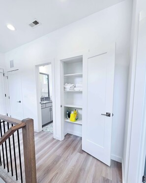 A modern bathroom with a white sink, mirror, and towel rack. - Balcony | 5 Min to Duke + Downtown (Durham)