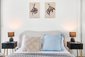 A bedroom with a bed, two bedside tables, two lamps, and two wall-mounted artworks. - Tiara Southbank 2BR Pool & Parking. Walk to Crown (Southbank)