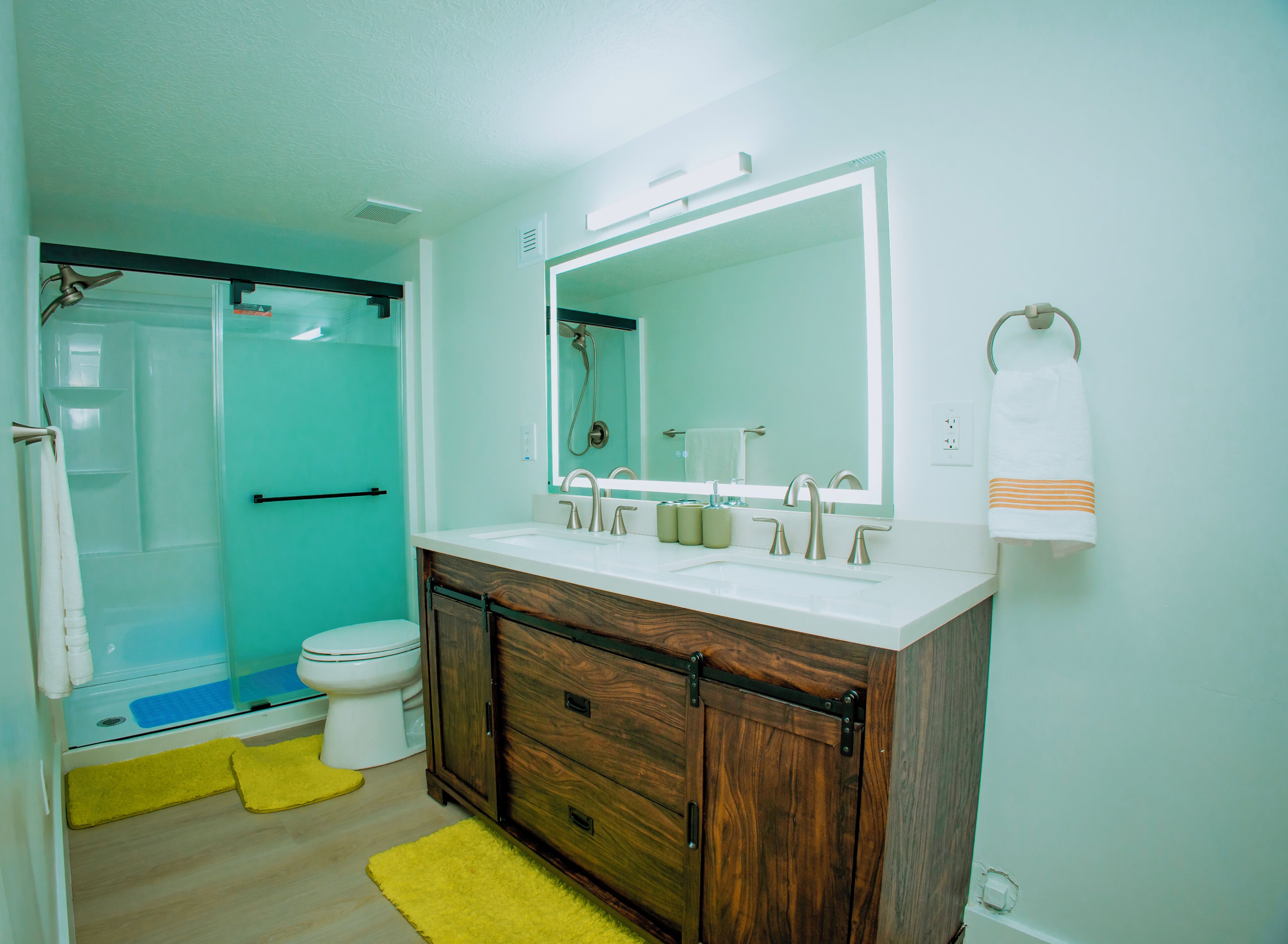 A bathroom with a shower, toilet, and sink.