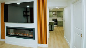 Ein modernes Wohnzimmer mit Flachbildfernseher und Kamin.