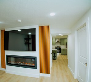 A modern living room with a flat-screen TV and a fireplace. - Brand New 2BR Basement Suite +1 King Bed & Private Entrance (South Jordan)