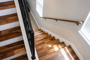 A staircase with wooden steps and a metal handrail. - East Austin, Walkable, Private Hot Tub and Parking (Austin)