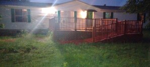 A house with a front porch and a red railing.